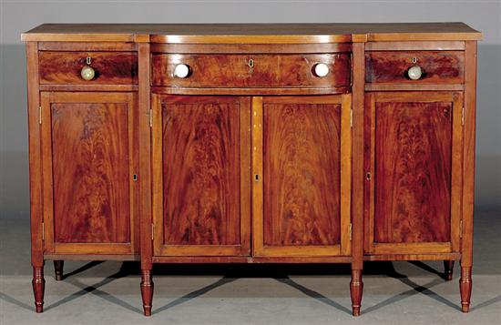 Appraisal: American mahogany breakfront sideboard circa shaped top over configuration of