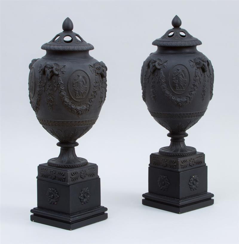 Appraisal: PAIR OF WEDGWOOD AND BENTLEY POTTERY BLACK BASALT URNS AND