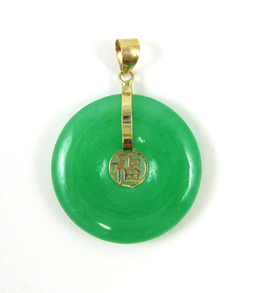 Appraisal: JADE AND FOURTEEN KARAT GOLD PENDANT with a large green