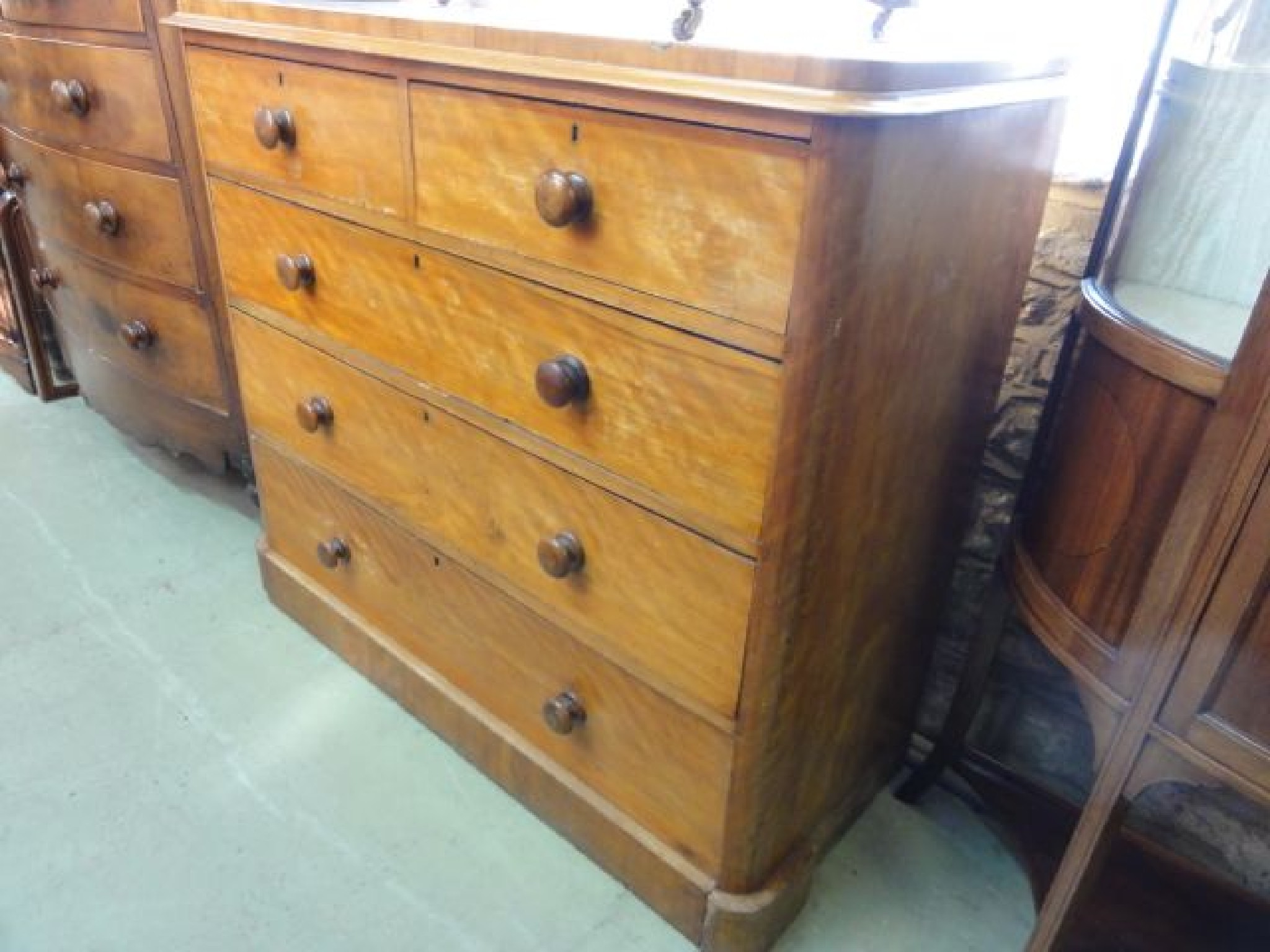 Appraisal: A Victorian satin walnut bedroom chest of three long and