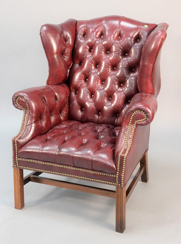 Appraisal: Tufted leather wing chair having brass rivets ht wd Tufted