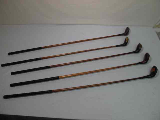 Appraisal: Fancy face wood shaft golf clubs total Includes an Arthur