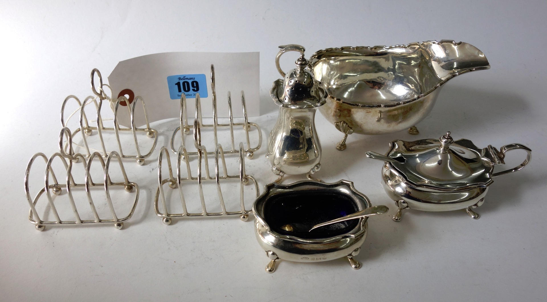 Appraisal: A set of four small silver wirework five-bar toast racks