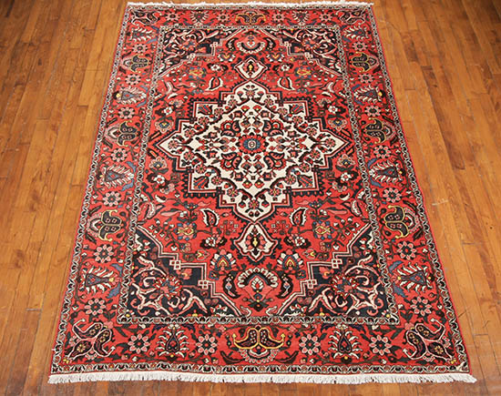 Appraisal: Bakhtiari Rug Contemporary Red ground with rosette and floral spray