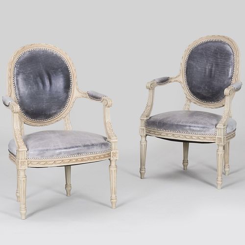 Appraisal: PAIR OF LOUIS XVI STYLE WHITE PAINTED AND LEATHER FAUTEUILS