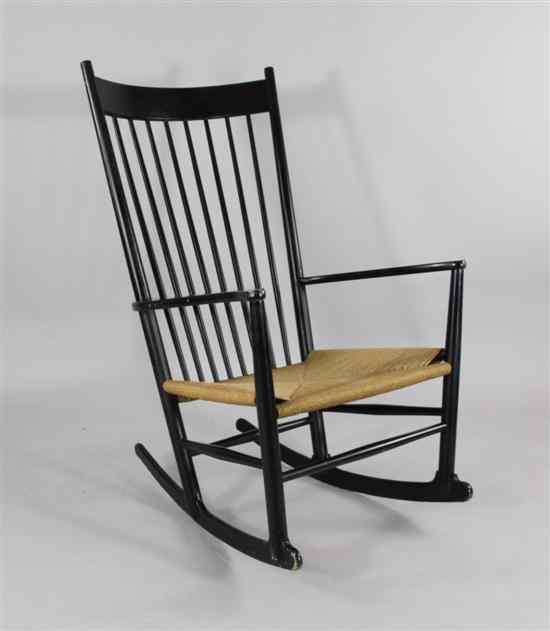 Appraisal: A Hans Wegner ebonised rocking chair with rush seat stamped