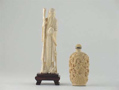 Appraisal: A Chinese ivory carving of Shoulao standing holding a gnarled