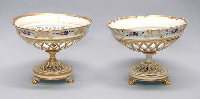 Appraisal: Oval reticulated basket on stand with gilt trim and paw