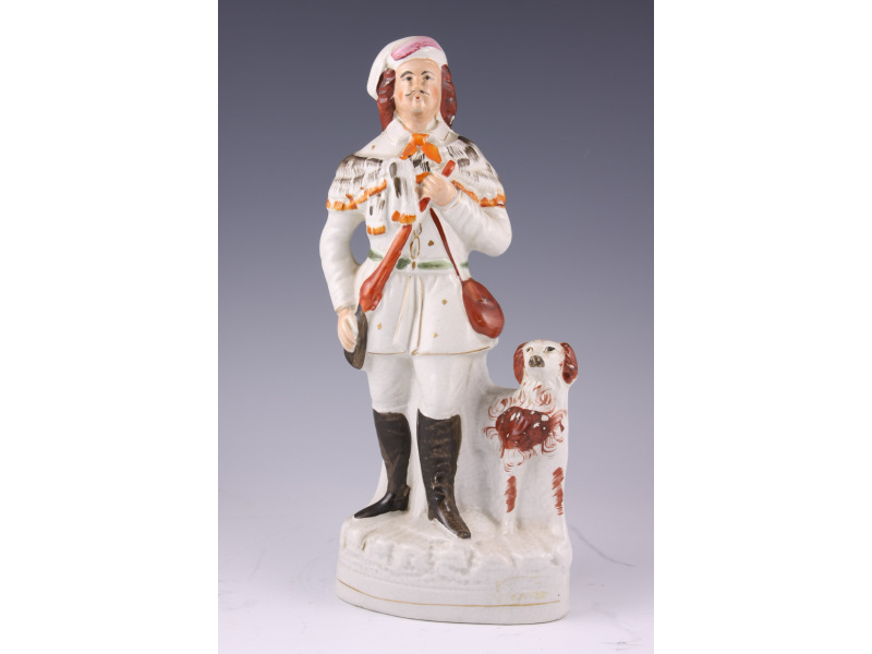 Appraisal: Staffordshire Figurine English ca a hunter and his dog Molded