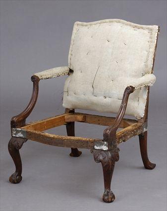 Appraisal: CHIPPENDALE CARVED MAHOGANY ARMCHAIR The padded back with serpentine crest