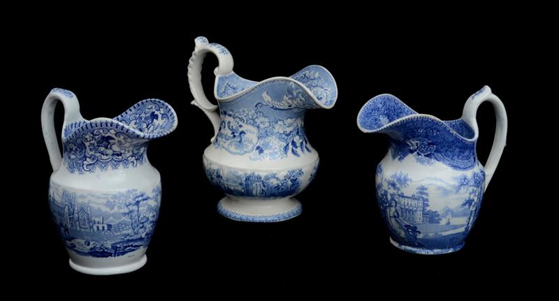 Appraisal: THREE STAFFORDSHIRE BLUE TRANSFER-PRINTED PITCHERS Comprising Stone China Adelaide's Bower