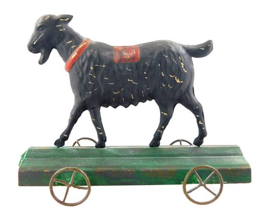 Appraisal: Tin goat on wheels toy th C older polychrome paint