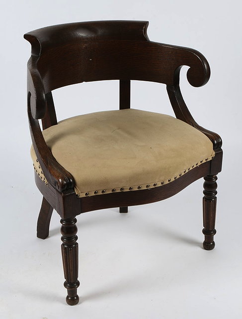 Appraisal: A FRENCH OAK TUB ARMCHAIR with serpentine front and fluted