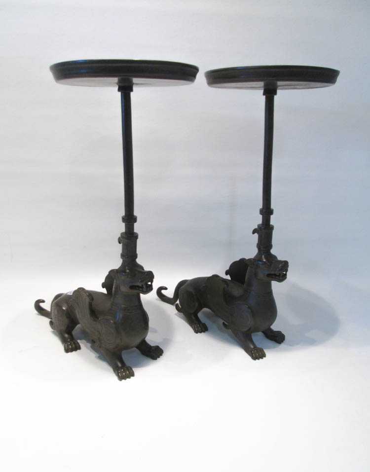 Appraisal: PAIR OF CHINESE FIGURAL BRONZE CANDLESTICKS featuring mythological winged dragon