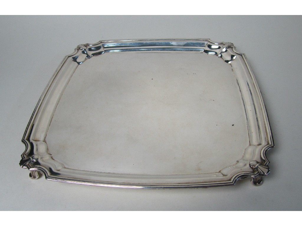 Appraisal: A silver card tray with canted corners on scroll feet