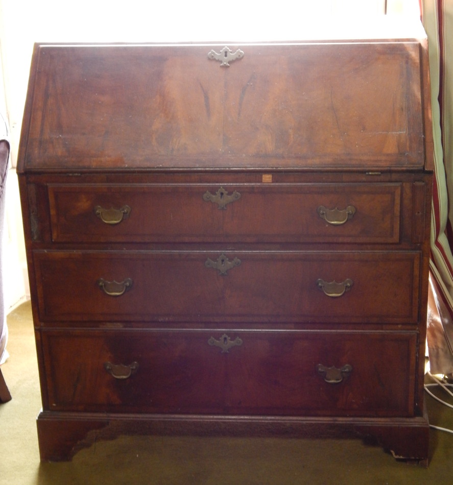 Appraisal: A George II walnut bureau with herringbone crossbanding to fall