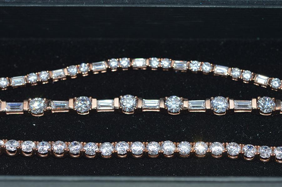 Appraisal: THREE CUBIC ZIRCONIA LINE BRACELETS IN ROSE COLOURED SILVE GILT