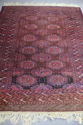 Appraisal: A Bokarah style rug of crimson ground the central field