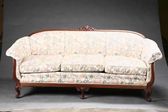 Appraisal: UPHOLSTERED SOFA Oak with a carved crest on short cabriole