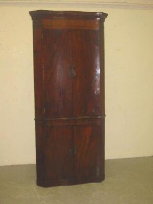 Appraisal: A GEORGE III MAHOGANY STANDING CORNER CUPBOARD of serpentine form