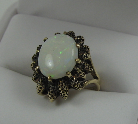 Appraisal: OPAL AND EIGHTEEN KARAT GOLD RING centered and prong set