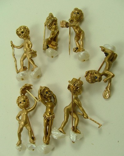 Appraisal: A SET OF SEVEN GOLD ANGELIC CHERUB BROOCHES Vera Cryril