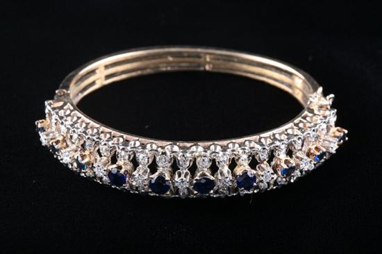 Appraisal: K YELLOW GOLD SAPPHIRE AND DIAMOND BANGLE BRACELET Raised and