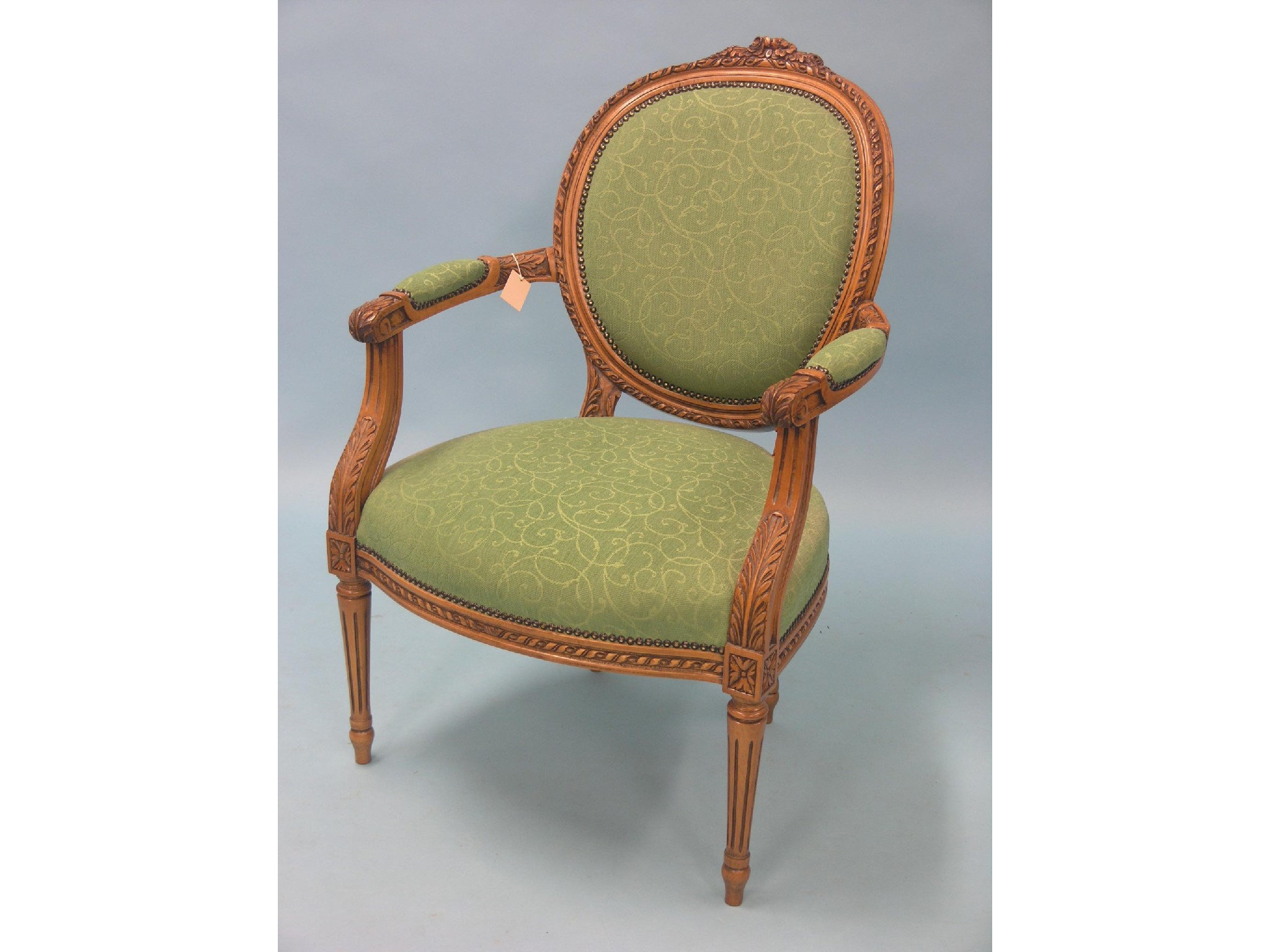 Appraisal: A Louis XVI-style light beech elbow chair by Stuart Jones