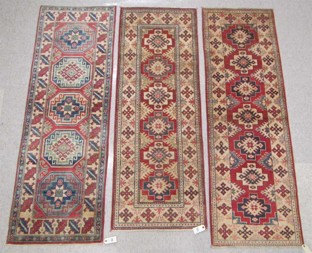 Appraisal: THREE HAND KNOTTED ORIENTAL AREA RUGS all Pakistani Caucasians repeating