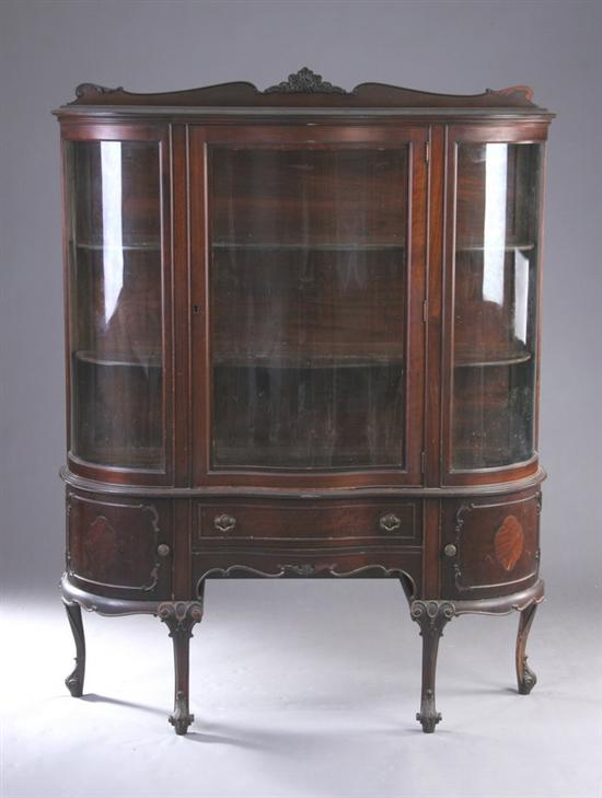 Appraisal: ROCOCO REVIVAL MAHOGANY CHINA CUPBOARD early th century Crested molded-edge