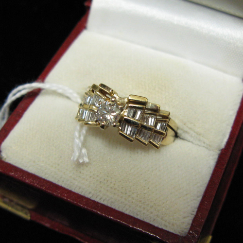 Appraisal: DIAMOND AND FOURTEEN KARAT GOLD WEDDING RING ENSEMBLE The engagement