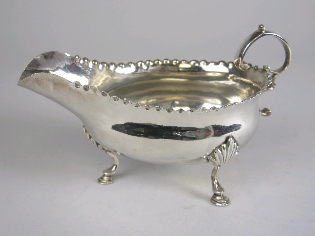 Appraisal: A George III Sauce Boat with shaped rim scroll handle