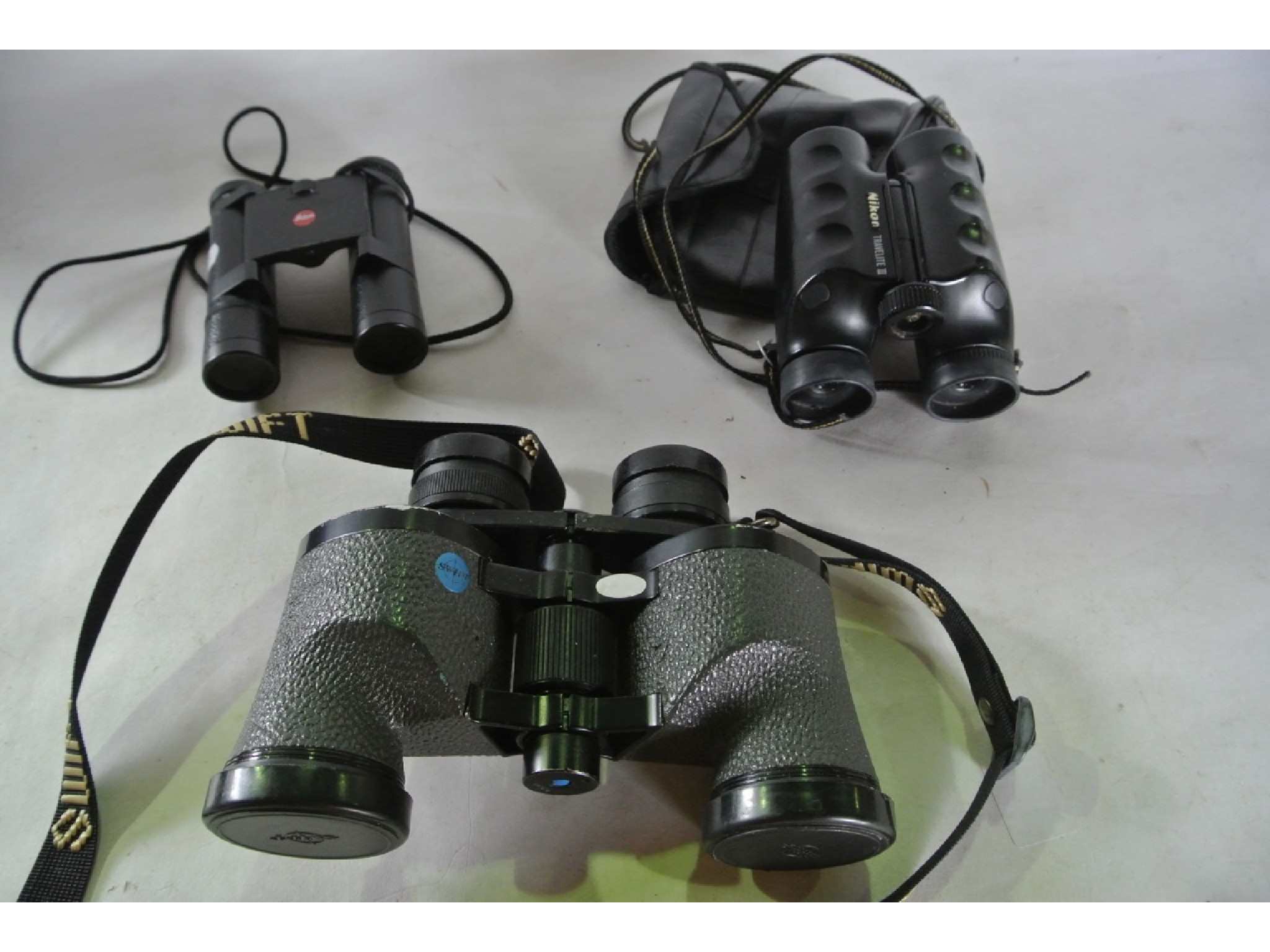 Appraisal: A pair of Leica Trinovid binoculars together with two further