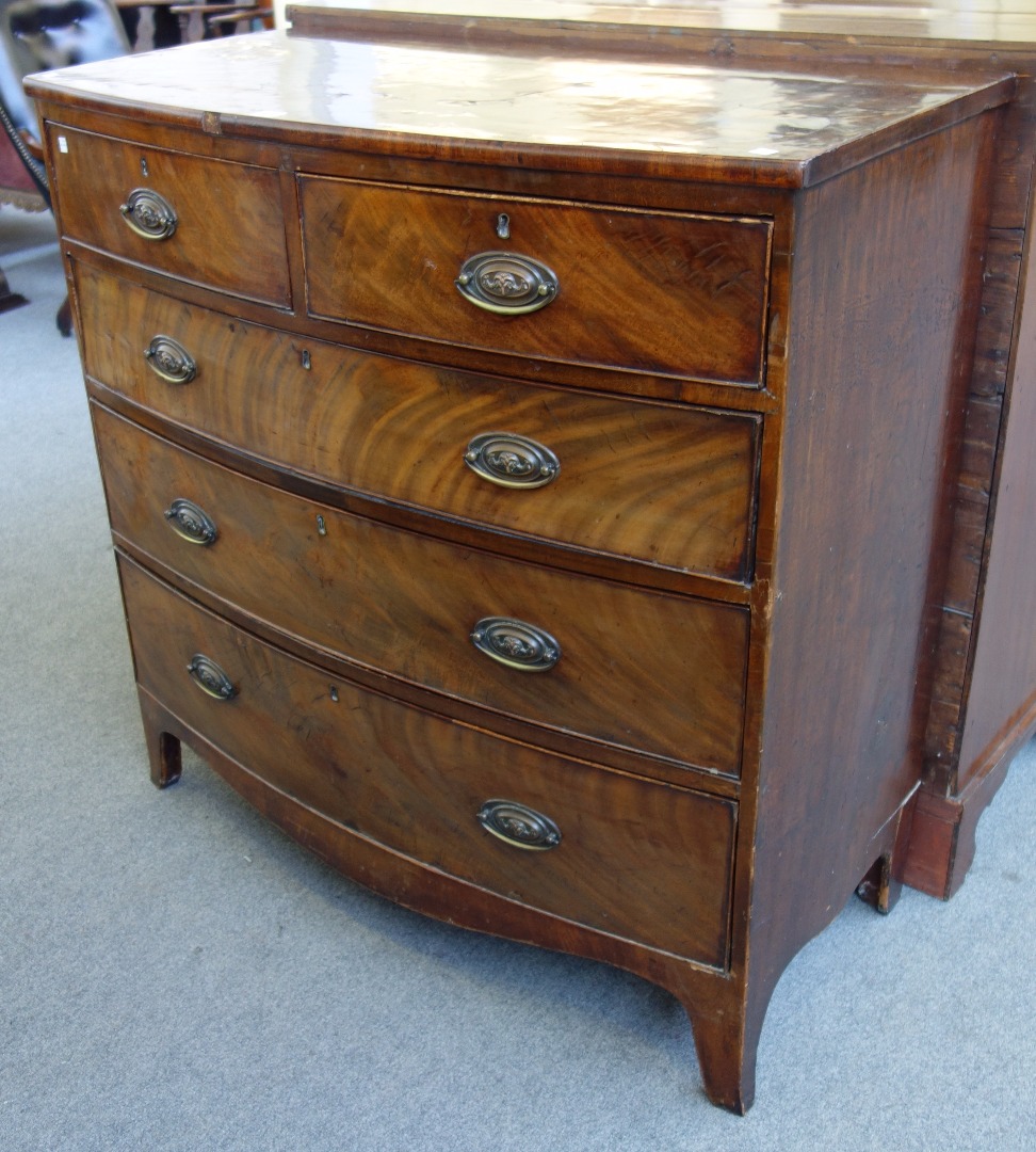 Appraisal: A George III bowfront mahogany chest of two short and