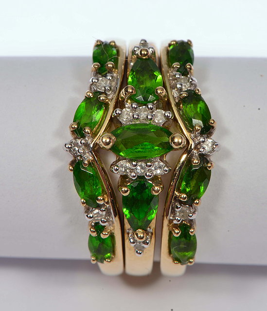 Appraisal: A GROUP OF THREE GREEN STONE SET RINGS coming together