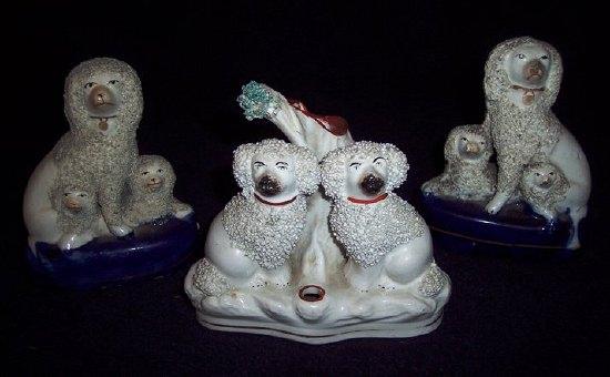 Appraisal: A pair of Staffordshire figures poodles with puppies cm high