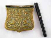 Appraisal: A brass box with raised decoration and a belt clip