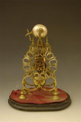 Appraisal: A brass skeleton clock with a single fusee movement striking