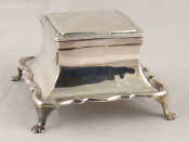 Appraisal: A silver square inkwell on moulded base with paw feet