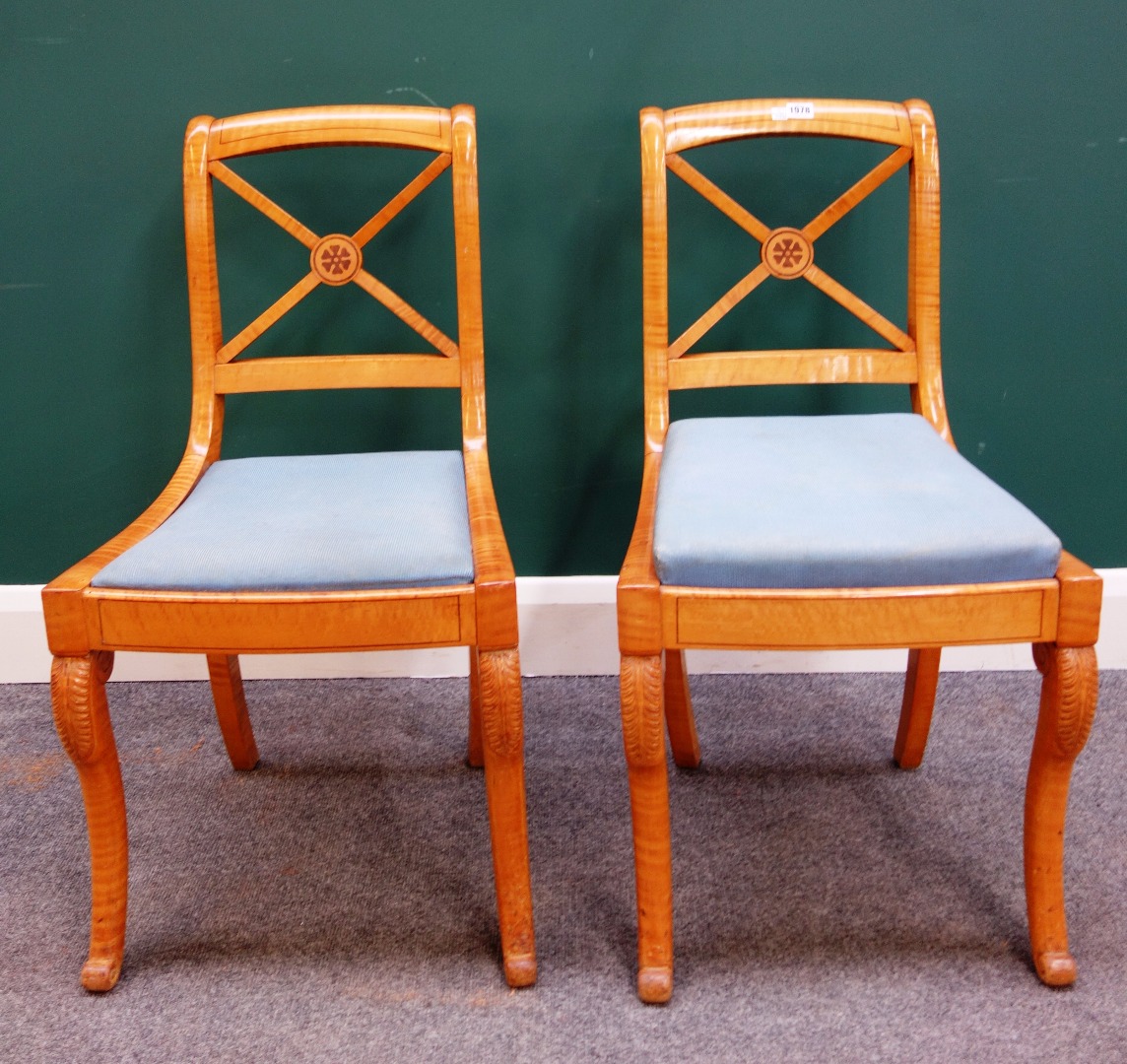 Appraisal: A set of four Biedermeier satin birch 'X' frame chairs