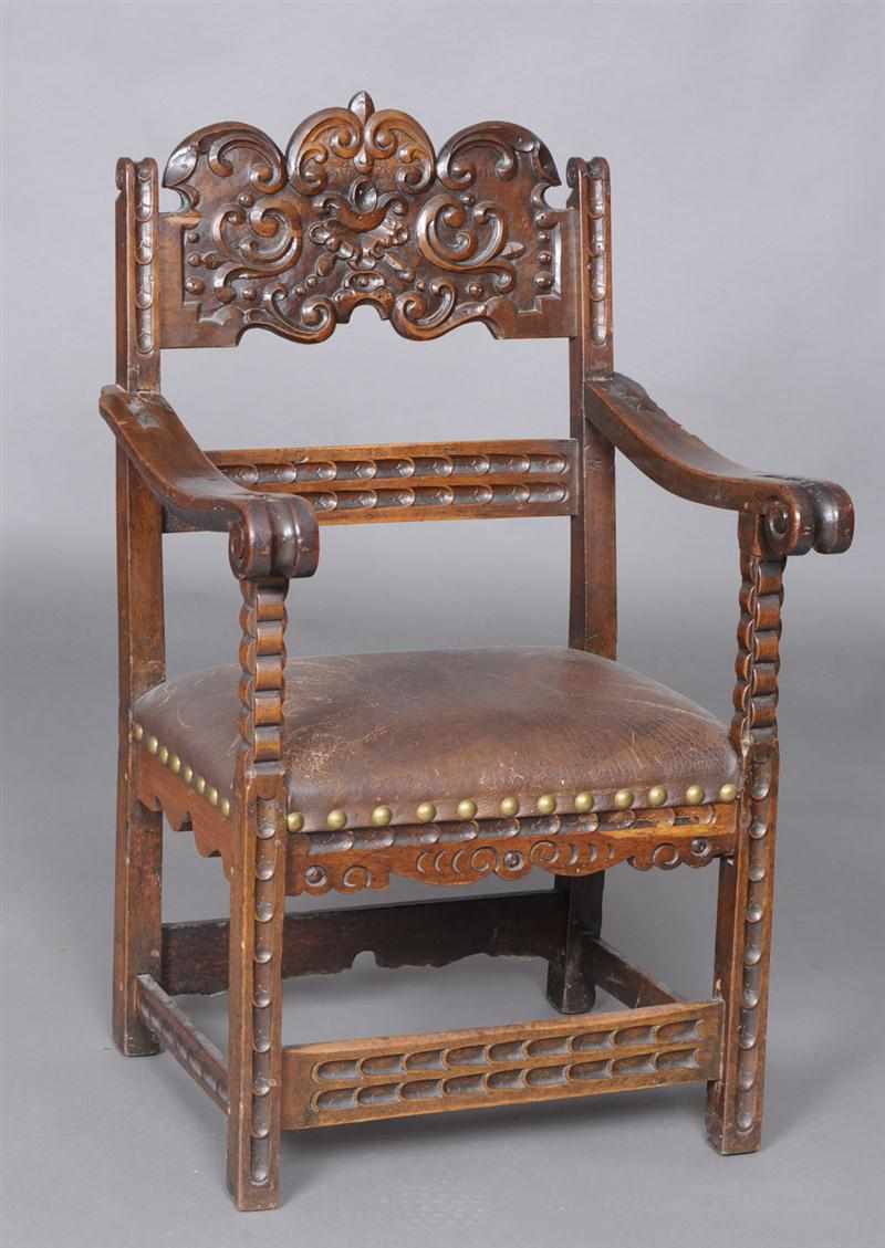 Appraisal: ITALIAN BAROQUE CARVED WALNUT ARMCHAIR The shaped relief-carved top rail