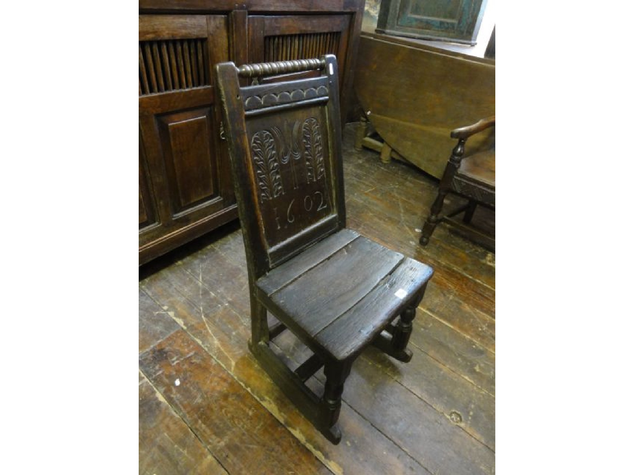 Appraisal: A small early oak panelled back chair with carved floral