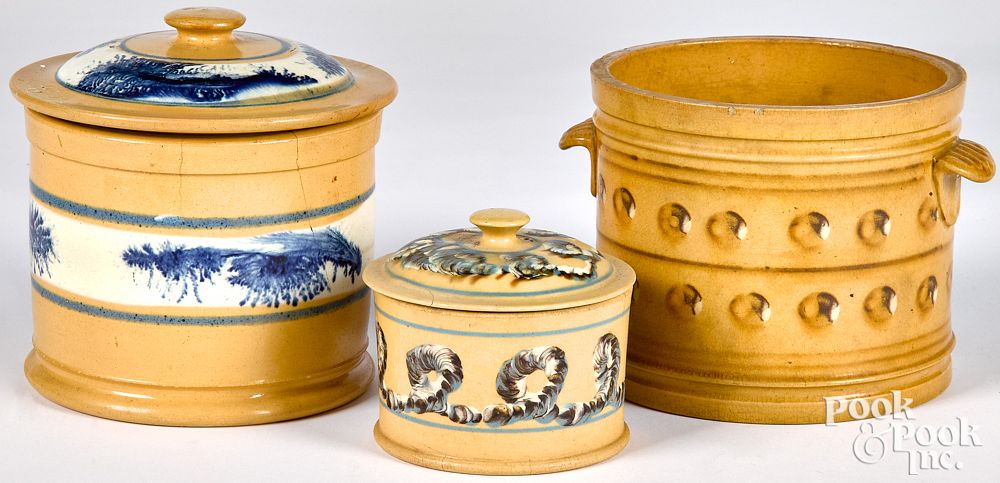 Appraisal: Three yellowware canisters Three yellowware canisters with mocha earthworm cat's-eye