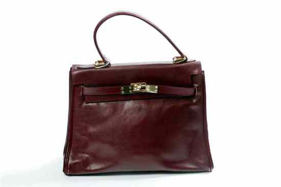 Appraisal: POURCHET BURGUNDY LEATHER KELLY-STYLE HANDBAG Includes lock and key fob