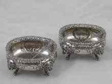 Appraisal: An ornate pair of Continental footed white metal tests silver