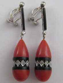 Appraisal: A pair of Art Deco style coral diamond onyx white