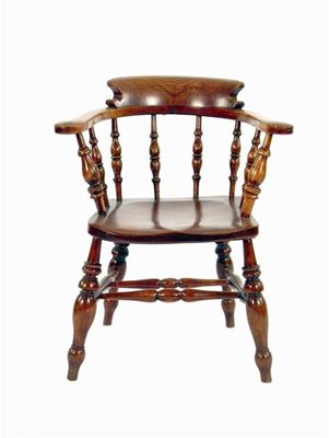 Appraisal: A beechwood and elm smoker's bow armchair the seat stamped