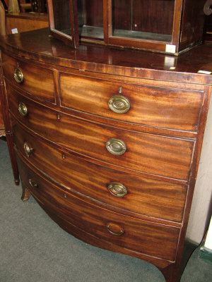 Appraisal: A mahogany bow front chest th century of two short