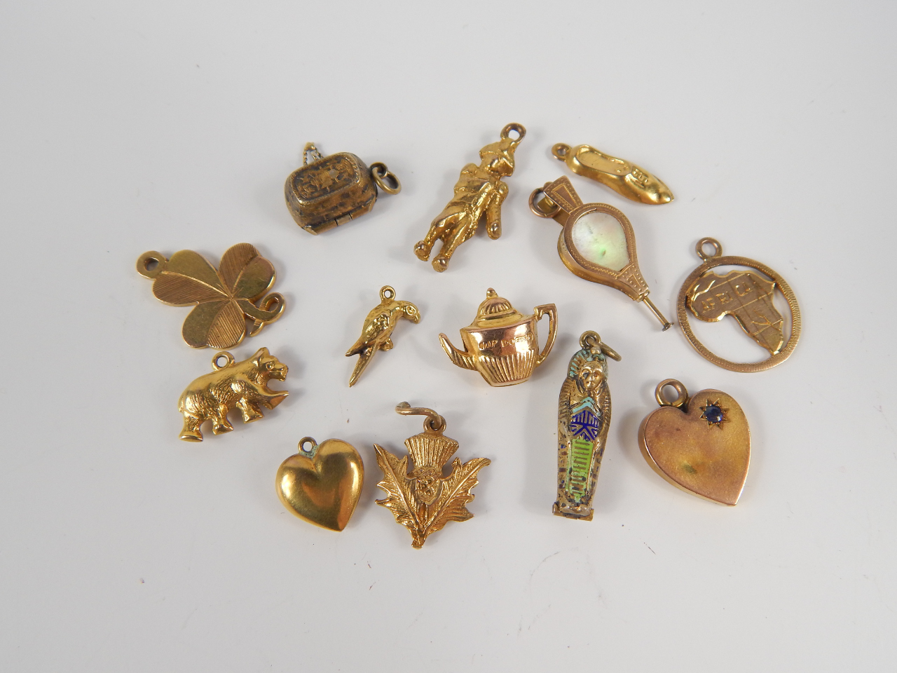 Appraisal: A collection of nine ct gold charms and others including