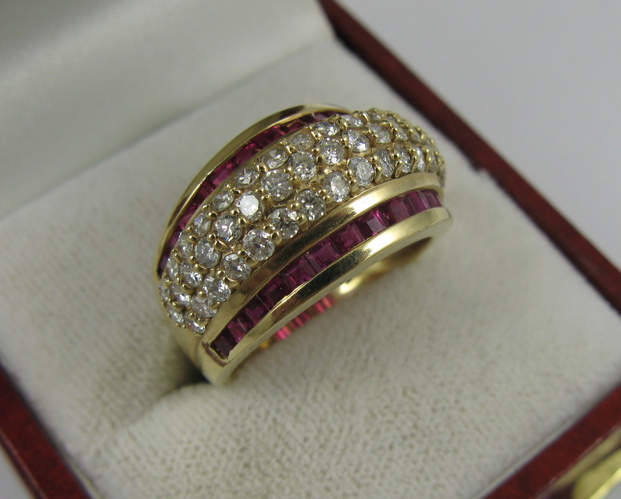 Appraisal: RUBY DIAMOND AND K GOLD RING set with two channels